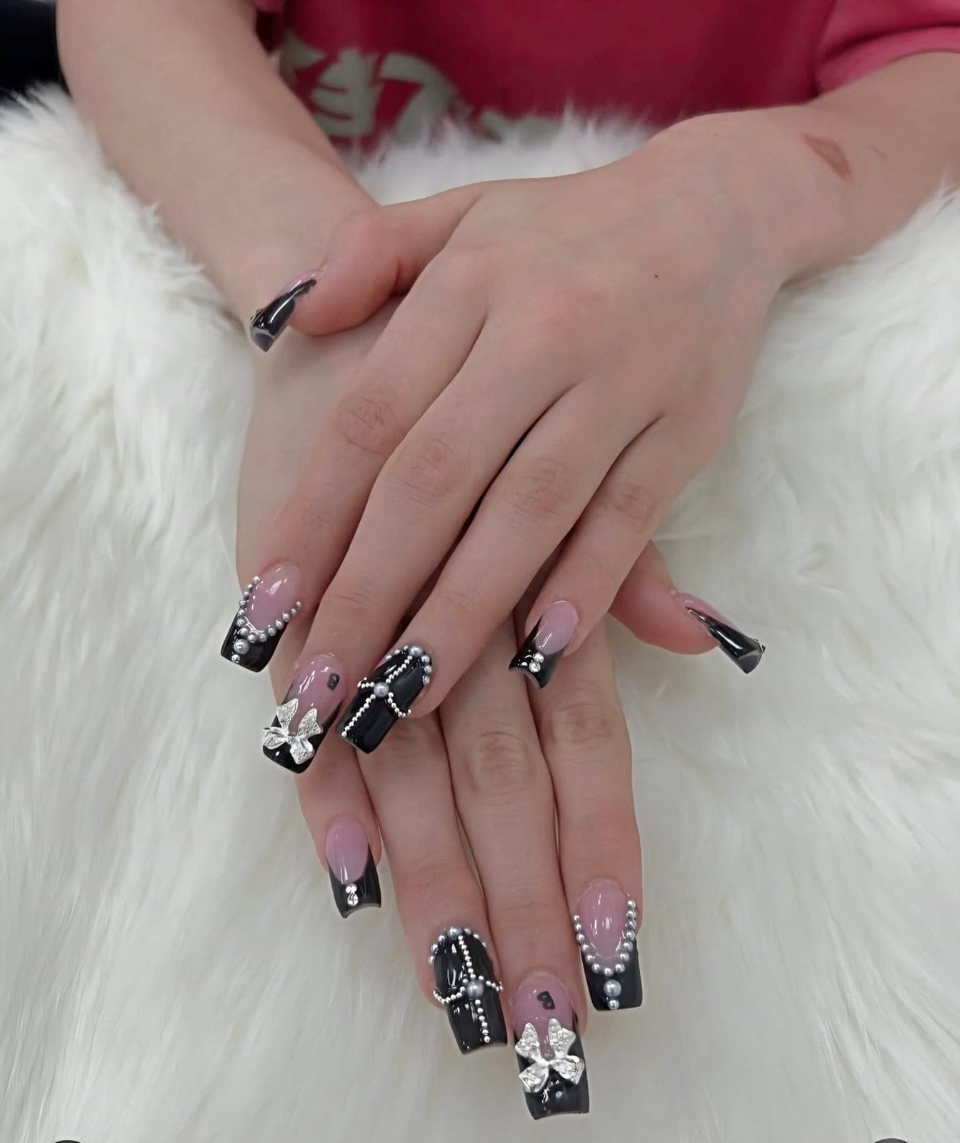 Black French nails with white flowers and crystals