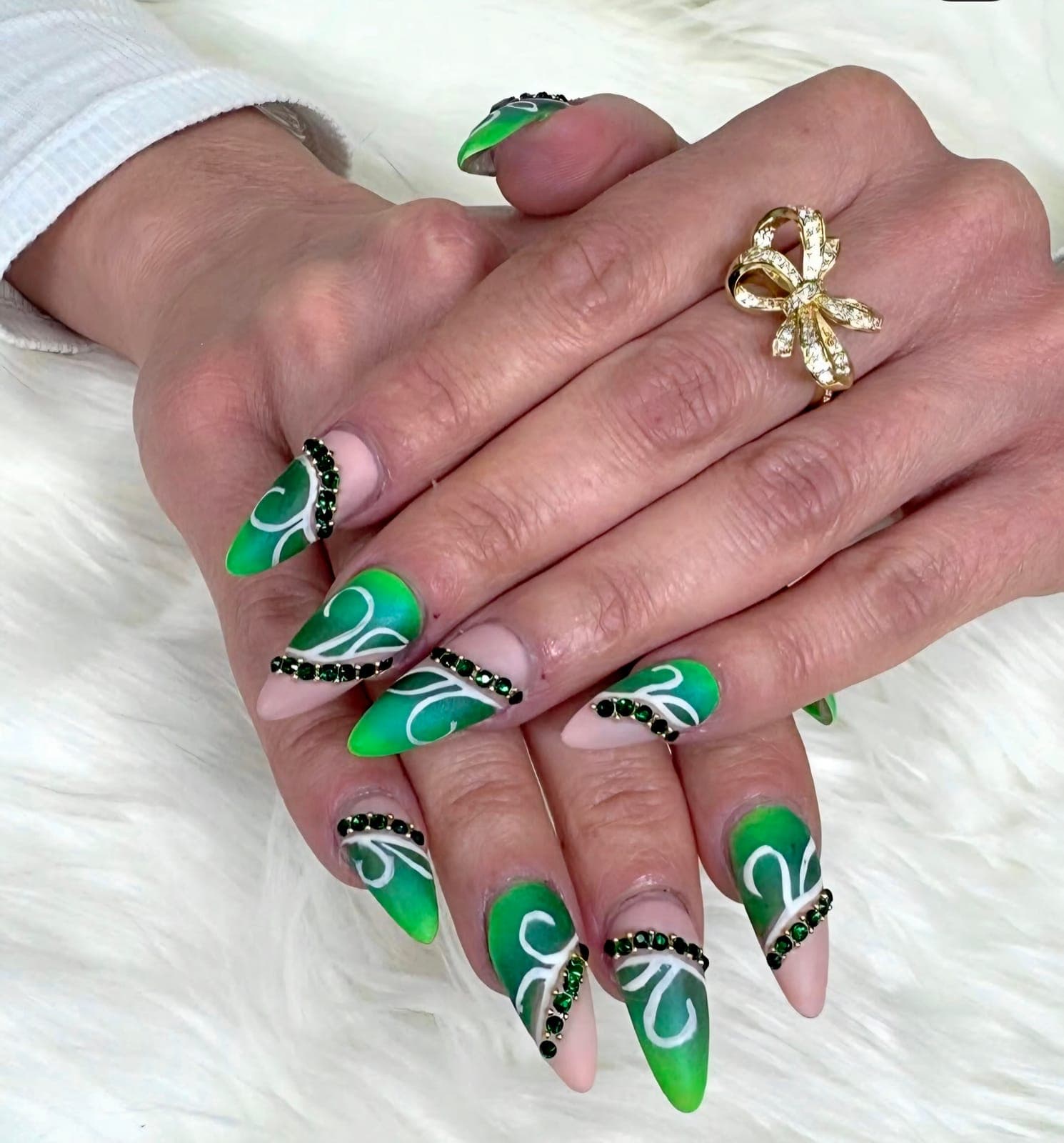 Green almond nails with white swirls and black crystals