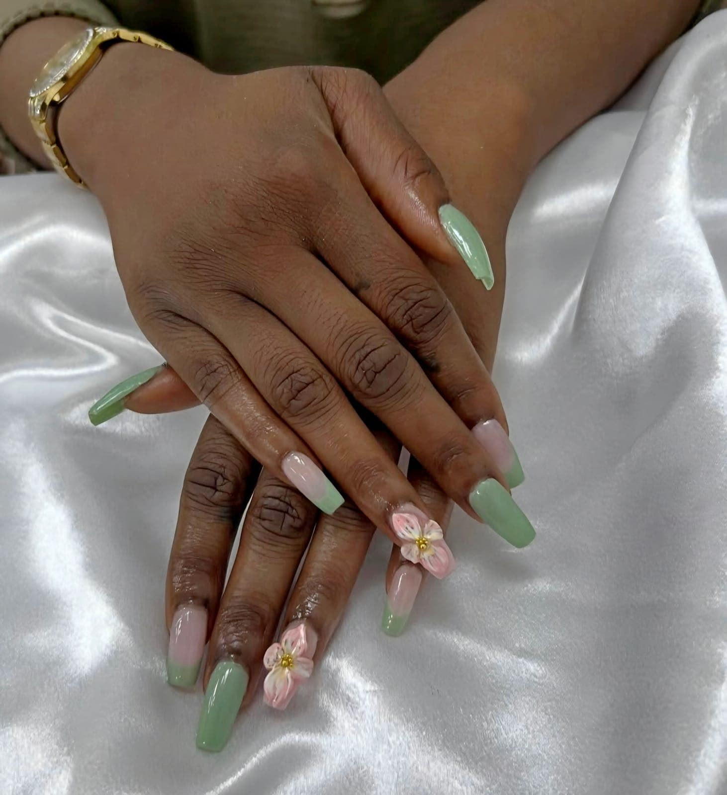 Sage green and nude nails with a 3D flower