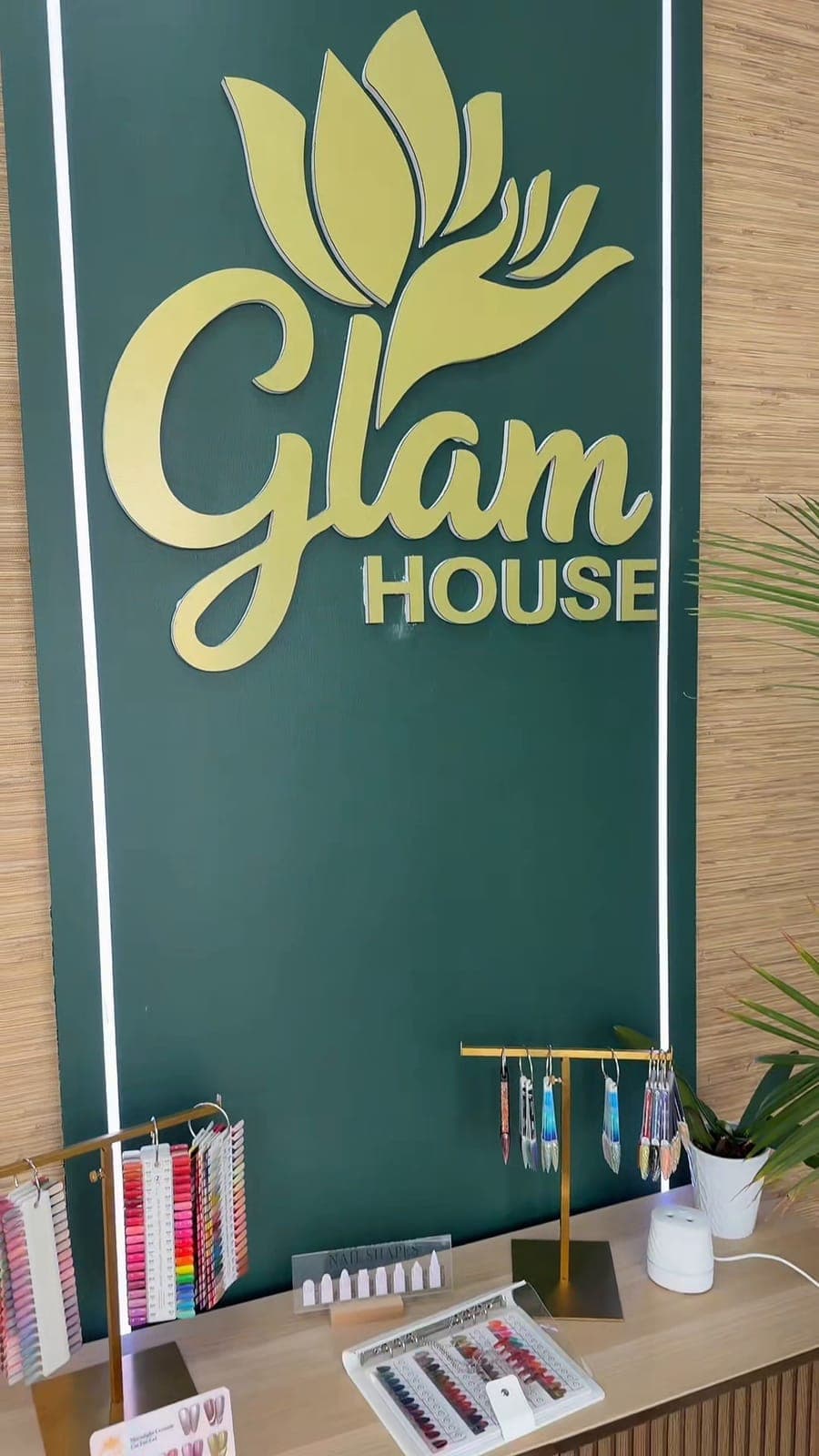 Gold Glam House logo on the green wall