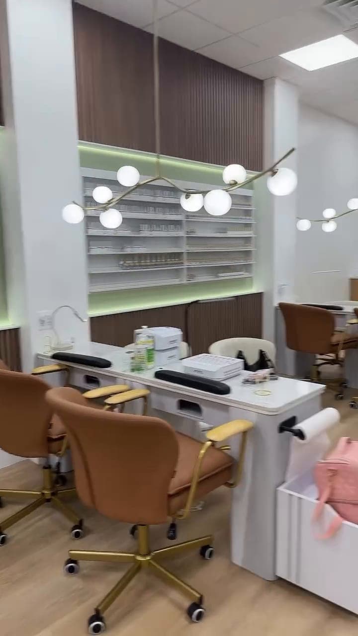 Manicure stations in front of the polish wall